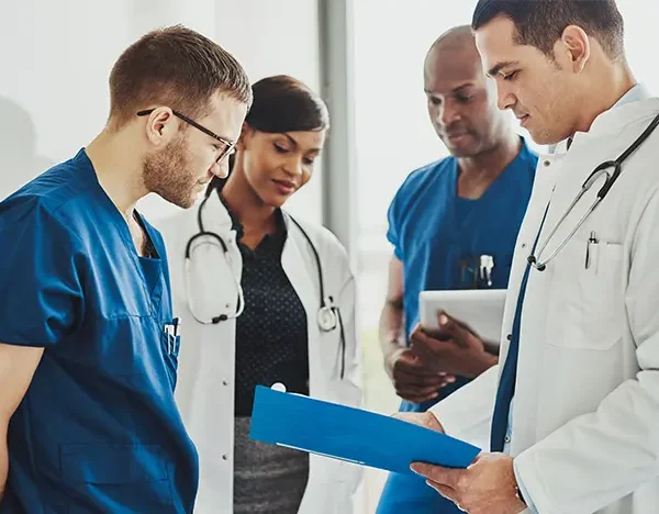 Medical-doctors-and-nurse-practitioners-discuss-paperwork-in-a-hallway.jpg Medical-doctors-and-nurse-practitioners-discuss-paperwork-in-a-hallway.jpg